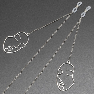 Silver anti-slip eyewear chain featuring unique abstract face silhouette pendants