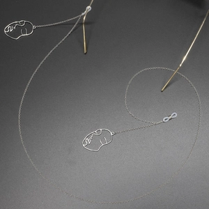 Silver non-slip eyewear chain with abstract face charms and silicone connectors