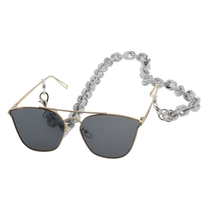 Detail of pilot sunglasses with a marble pattern acrylic chain and golden metal frames