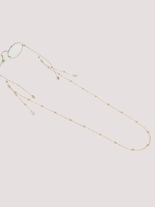 Detail of gold chain glasses strap with small beads and elegant pearl pendants