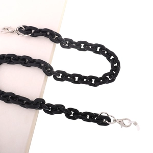 Close-up of thick black acrylic link chain with silver lobster clasps and silicone loops