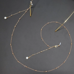 Elegant gold metal eyewear chain with white pearls and beads for glasses or face masks