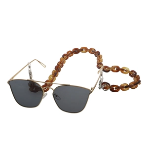 Detail of amber tortoiseshell acrylic eyewear chain on aviator sunglasses