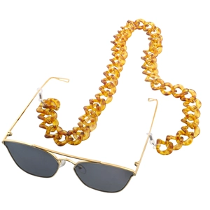 Chunky amber acrylic eyewear chain with vintage square leopard print links on white background