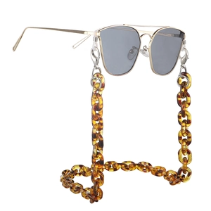 Close-up of tortoise shell resin chain attached to gold pilot sunglasses frame