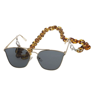 Detail of amber acrylic glasses chain with gold frame pilot sunglasses set