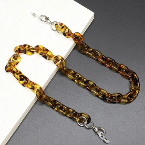 Detail of amber acrylic glasses chain with silver lobster clasps and silicone loops