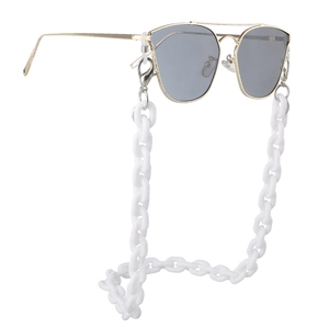 Detail of pilot sunglasses with gold metal frame and thick white acrylic link chain