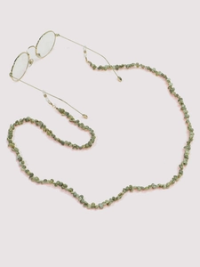 Close-up of light green seashell eyeglass chain with gold metal links and rubber ends