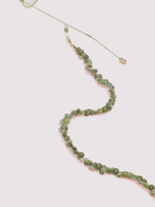 Close-up of green natural shell beads on a gold chain with anti-slip glasses connector