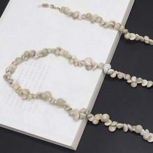 Snail shell eyewear chain with natural grey conch beads and golden anti-slip silicone loops