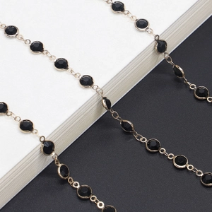 Handmade eyeglass chain with black glass beads and gold link chain in a stylish design