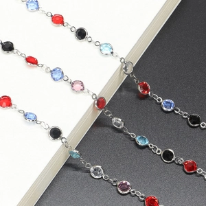 Detailed macro shot of multi-colored crystal beads with silver bezel setting links
