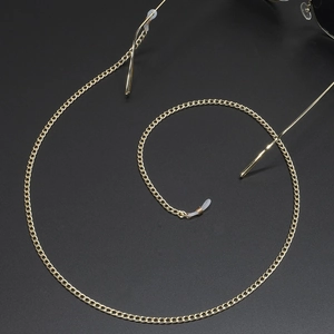 Elegant gold metal eyeglass chain with non-slip silicone loops on dark background