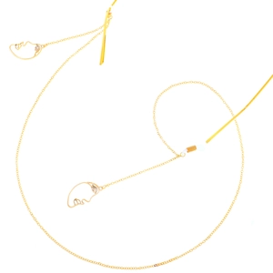 Golden metal eyewear chain with abstract hollow face pendants and non-slip silicone loops