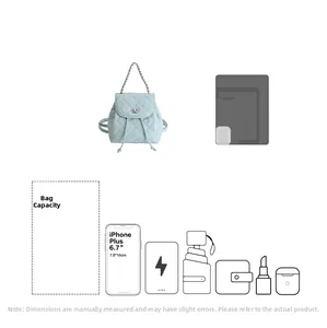 Capacity detail of light blue quilted mini backpack showing space for phone and accessories