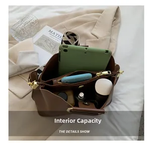 Interior view of brown bucket bag showing dual compartments and high storage capacity