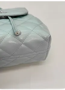 Detail of mint green quilted bag showing the widened bottom base and precise stitching