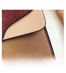 Close-up of color-block stitching details on a contrast panel shoulder bag