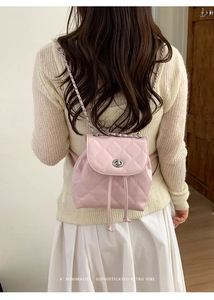 Pink quilted leather mini backpack with silver twist lock and woven chain strap details
