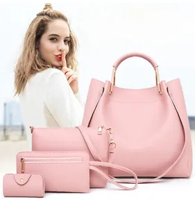 Pink faux leather four-piece bag set including tote and crossbody with gold hardware