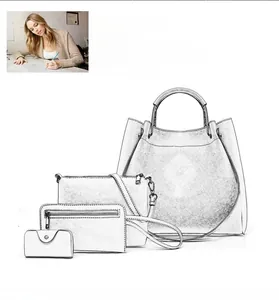 Macro view of four-piece handbag set featuring textured leather and metal hardware