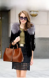 Brown oil-wax leather tote bag with large capacity and elegant top handles on urban street