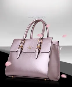 Detail shot of a purple metallic tote bag with top handles and decorative buckle design