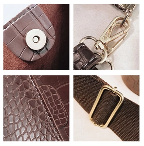 Detailed views of dark brown crocodile embossed leather with gold hardware and wide strap