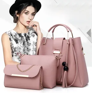 Detailed set of three dusty rose PU leather handbags with tassels and metal chain decor