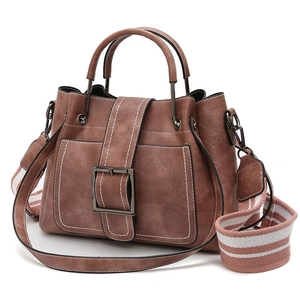 Brown vintage bucket bag with contrast stitching and wide striped fabric shoulder strap
