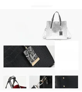 Detail view of crocodile pattern leather tote with metal hooks and protective bottom rivets