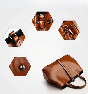 Vue détaillée du sac cabas en cuir marron vintage montrant le fini huilé et les boucles