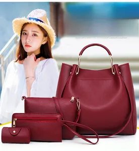 Detail of burgundy four-piece bag set with tote, crossbody, wallet and gold ring handles