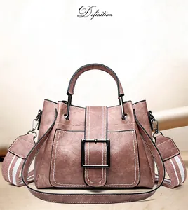 Detail of vintage bucket bag featuring distinctive large metal buckle and contrast stitching