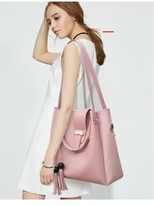 Detail of pink PU leather shoulder bag featuring metal rings and stylish fringe tassel