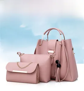 Detailed set of three pink PU leather handbags with metal handles and tassel accent