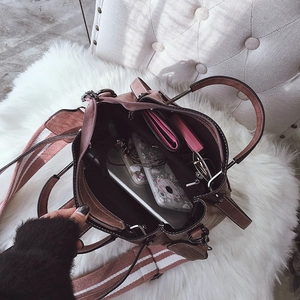 Detail view of pink bucket bag interior showing spacious capacity and wide strap