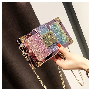 Macro detail of gradient pink sequin box bag with gold corner guards and push-lock