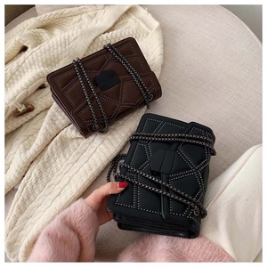 Detailed view of vintage square chain bags with geometric stud patterns and chain straps