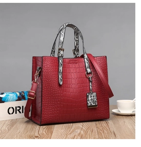 Close-up of red faux crocodile leather texture and snakeskin patterned handle