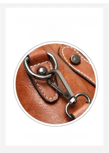 Detail of durable gunmetal hardware hook on brown leather bucket bag with pebble texture