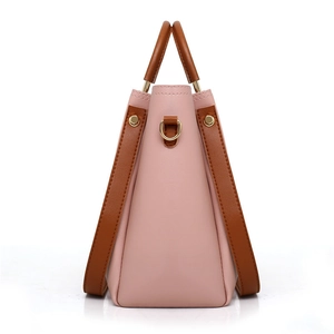 Pink and brown two-tone faux leather handbag set with gold hardware on white background