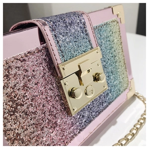Close-up of glitter sequins and gold metal lock on pink gradient box crossbody bag