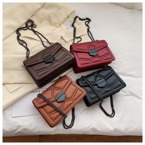 Detail display of vintage leather crossbody bags with metal chains in multiple colors
