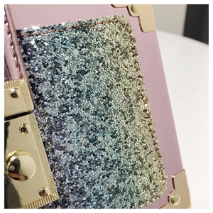 Macro view of pink leather bag featuring gradient sequins and gold metal corner guards