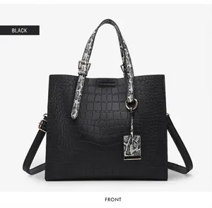 Front detail of black crocodile pattern tote bag with snakeskin texture accents