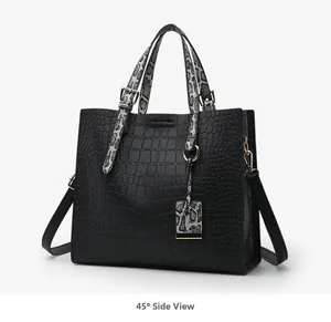 Side 45-degree view of a black crocodile pattern handbag with snake skin texture accents