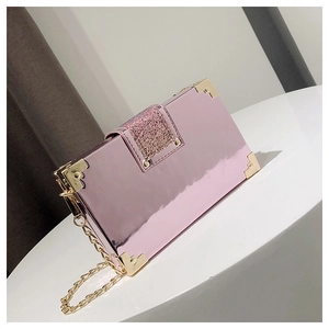 Detail of pink mirror box bag with metallic corners, sequins and golden chain strap