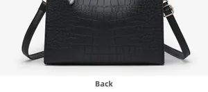 Detailed back view of a black crocodile pattern leather handbag with shoulder strap